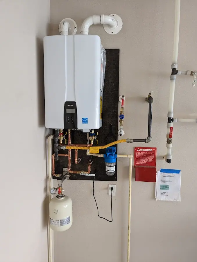 Professional plumber installing copper piping in a Eastmont home